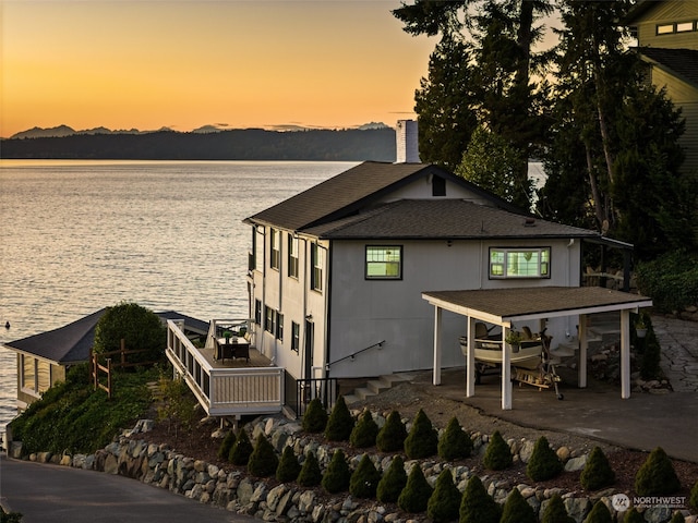 exterior space with a water view and a patio area