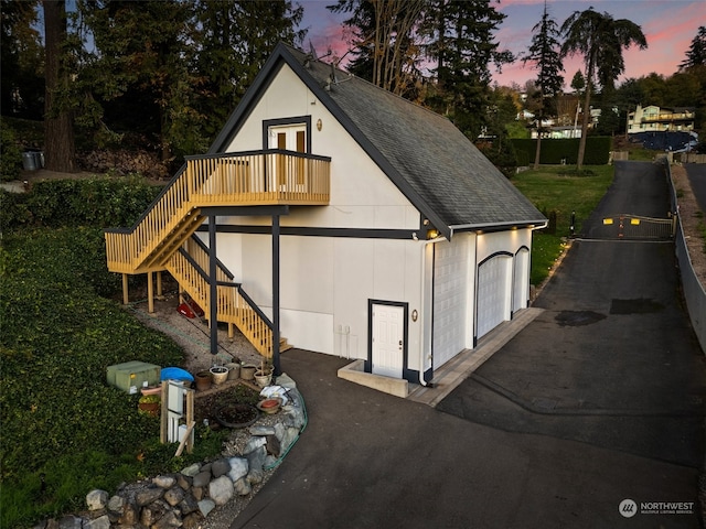 outdoor structure at dusk featuring a garage