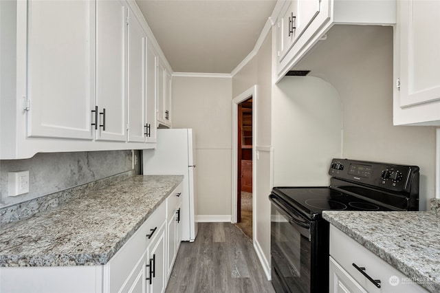 kitchen with white cabinetry, black electric range, light hardwood / wood-style floors, crown molding, and light stone counters