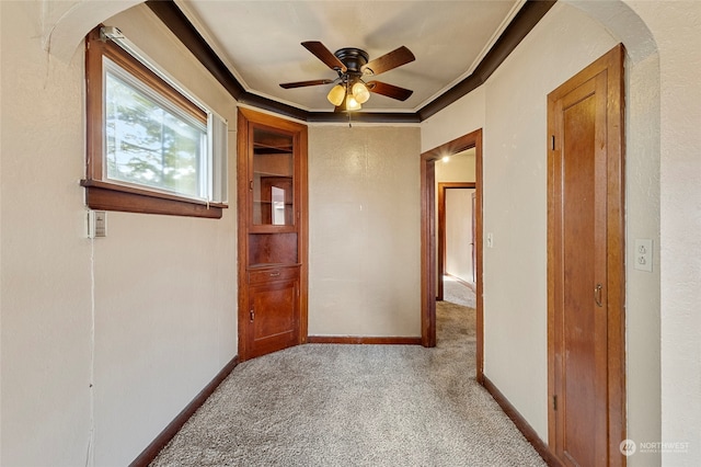 carpeted spare room featuring ornamental molding and ceiling fan