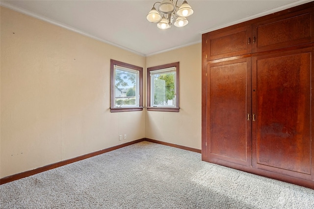 unfurnished bedroom featuring ornamental molding, a chandelier, and light colored carpet