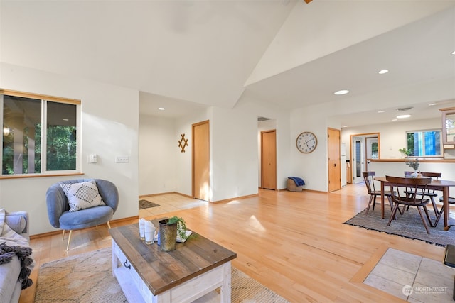 living room with lofted ceiling and light wood-type flooring