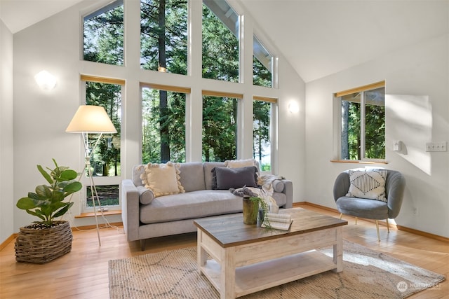 sunroom / solarium featuring lofted ceiling and a wealth of natural light