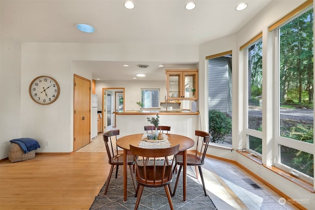 dining space with light hardwood / wood-style flooring and a wealth of natural light