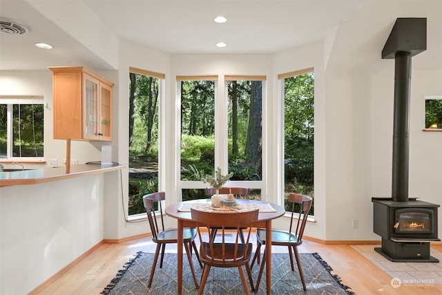 sunroom featuring a wood stove