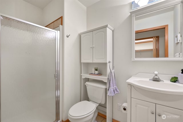 bathroom with vanity, toilet, and a shower with door