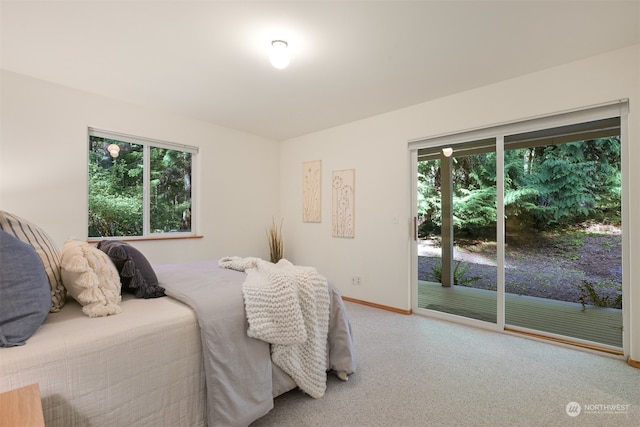 carpeted bedroom with access to exterior