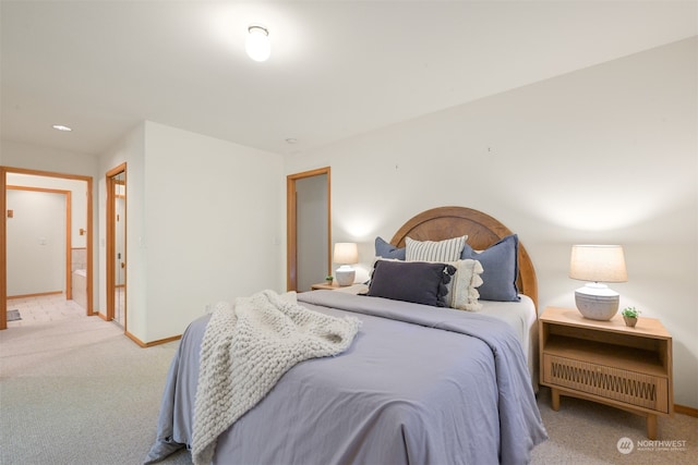 carpeted bedroom featuring ensuite bath