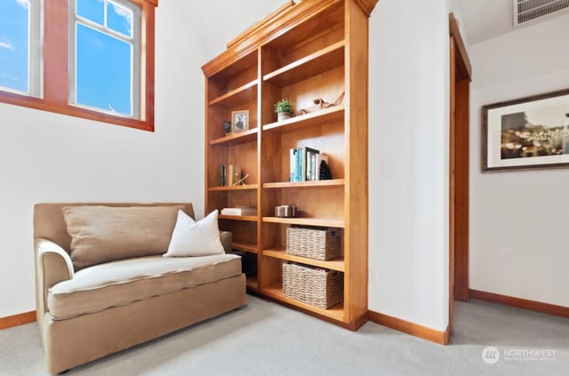 sitting room with visible vents, baseboards, and carpet flooring