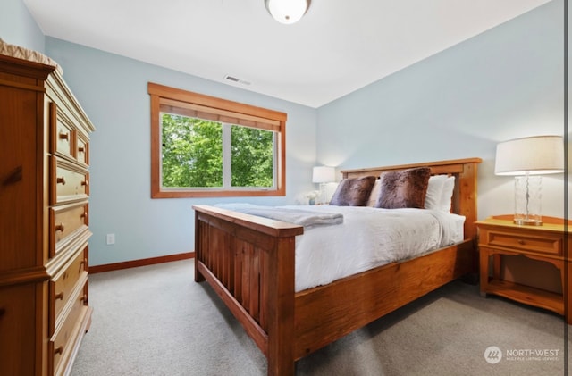 bedroom with visible vents, light colored carpet, and baseboards