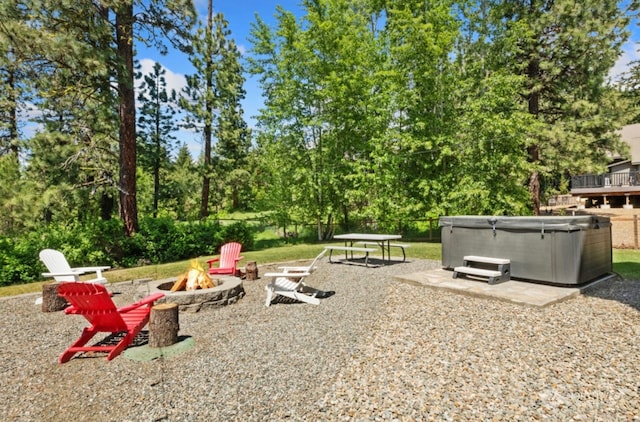 view of yard with a patio, a fire pit, and a hot tub