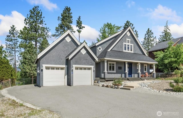 view of front facade featuring aphalt driveway, covered porch, a garage, and fence