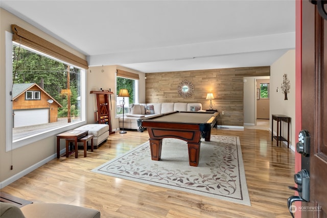 recreation room with wooden walls, pool table, and light hardwood / wood-style floors