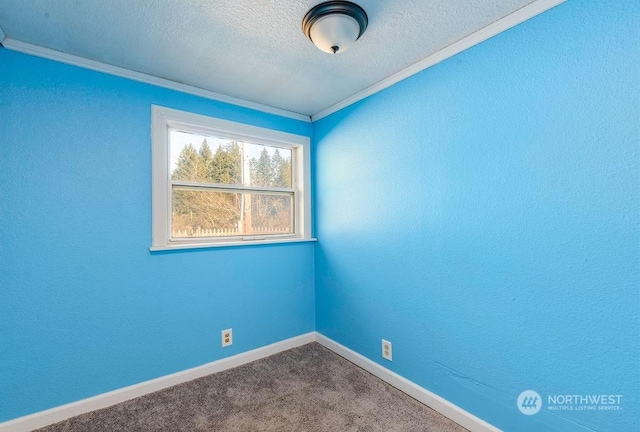 spare room with baseboards, a textured wall, crown molding, a textured ceiling, and carpet flooring