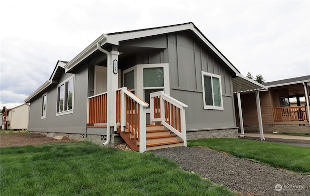 exterior space with a porch and a lawn