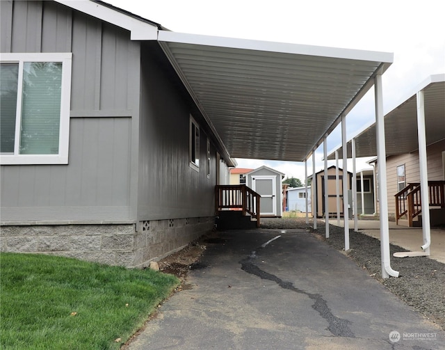 1111 Archwood Dr SW Unit 324, Olympia, WA 98502 - view of car parking with a storage unit and a carport