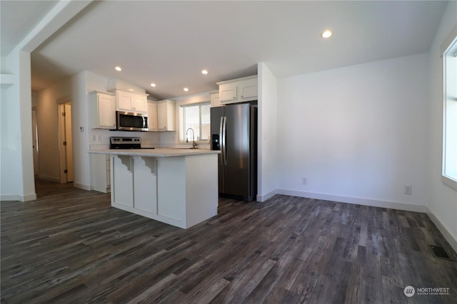 1111 Archwood Dr SW Unit 324, Olympia, WA 98502 - kitchen featuring appliances with stainless steel finishes, a sink, dark wood-style floors, light countertops, and recessed lighting