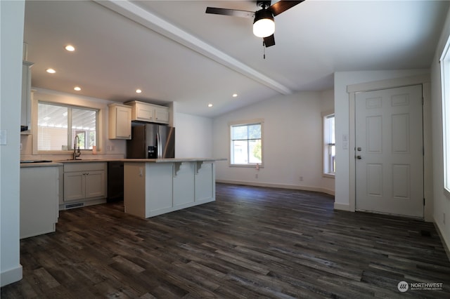 kitchen with a center island, stainless steel fridge with ice dispenser, lofted ceiling with beams, white cabinetry, and dark hardwood / wood-style flooring