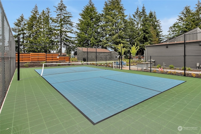 view of property's community featuring tennis court