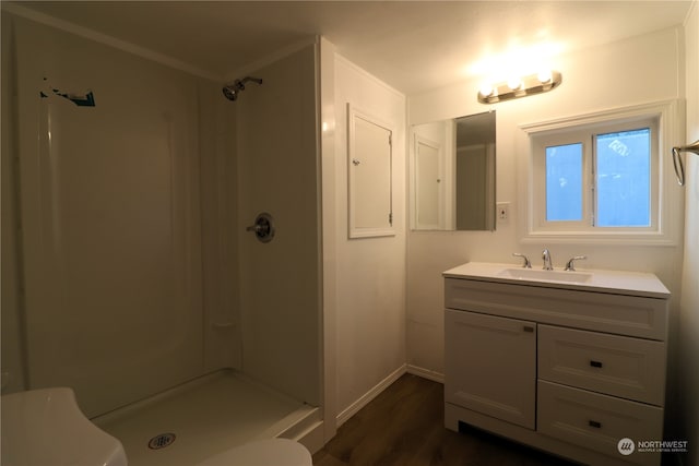 bathroom featuring toilet, hardwood / wood-style floors, vanity, and walk in shower