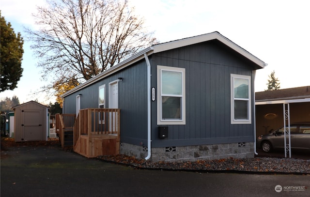 view of property exterior with a storage unit and a carport