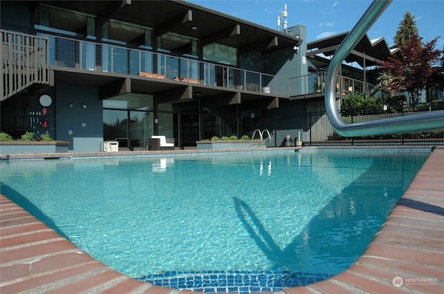 view of pool featuring a water slide