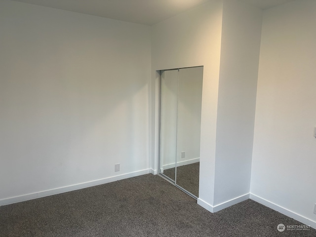 unfurnished bedroom with carpet flooring and a closet