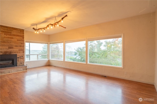 835 S Kiefer Dr, Moses Lake, WA 98837 - unfurnished living room featuring wood finished floors, baseboards, and a stone fireplace
