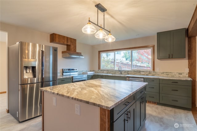 kitchen featuring stainless steel appliances, sink, light stone countertops, hanging light fixtures, and a center island