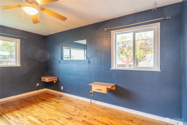 empty room featuring wood-type flooring and ceiling fan