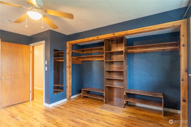 unfurnished bedroom featuring hardwood / wood-style flooring, ceiling fan, and a closet