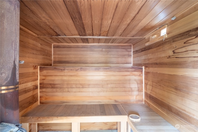 view of sauna / steam room featuring wood walls and wooden ceiling