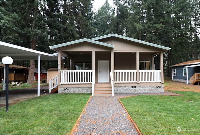 bungalow-style house featuring a front yard, a carport, and a porch