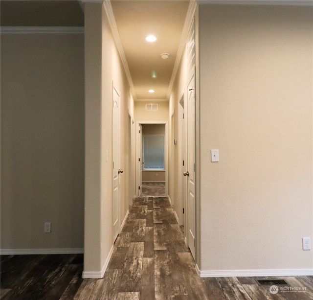 hallway featuring ornamental molding and dark hardwood / wood-style floors