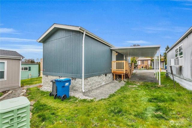 view of property exterior with a yard and a carport