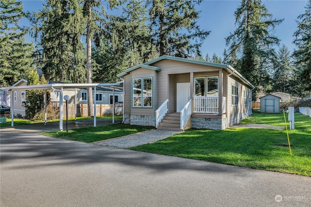 view of front of home with a front yard and a storage shed