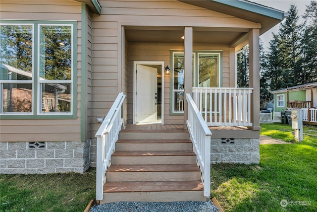 doorway to property with a yard