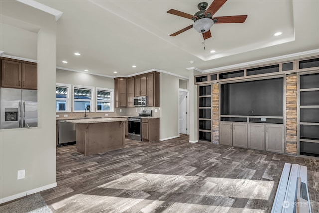 kitchen featuring a kitchen island, appliances with stainless steel finishes, built in shelves, and dark hardwood / wood-style floors