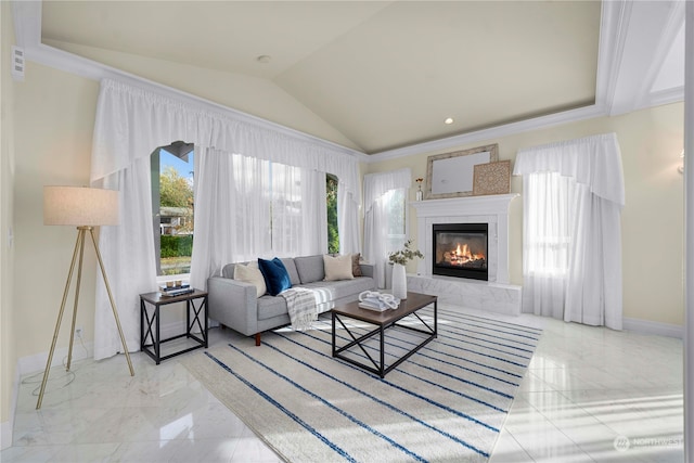 living room with ornamental molding, vaulted ceiling, and a tile fireplace