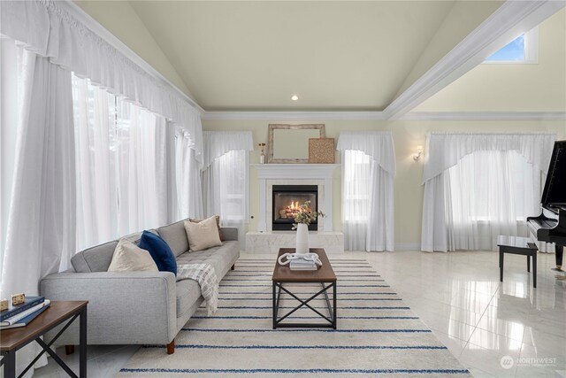 living room with light tile patterned floors, vaulted ceiling, and a tile fireplace