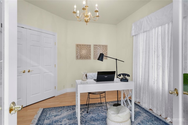 office area with a notable chandelier and hardwood / wood-style flooring