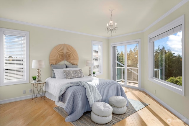 bedroom featuring ornamental molding, light hardwood / wood-style flooring, a notable chandelier, and access to outside