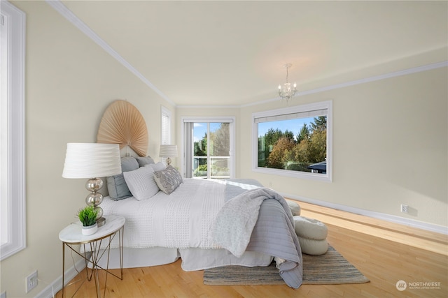 bedroom with crown molding, wood-type flooring, and a chandelier