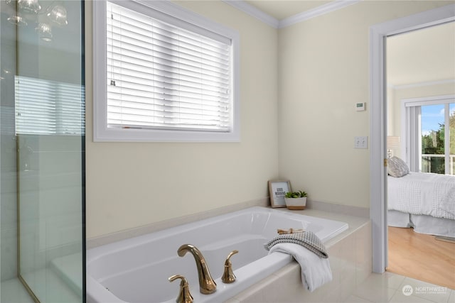 bathroom with tile patterned floors, crown molding, and independent shower and bath