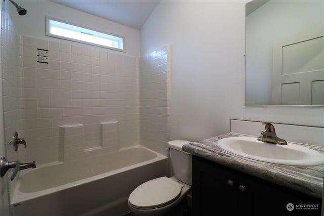 full bathroom with vanity, lofted ceiling, washtub / shower combination, and toilet