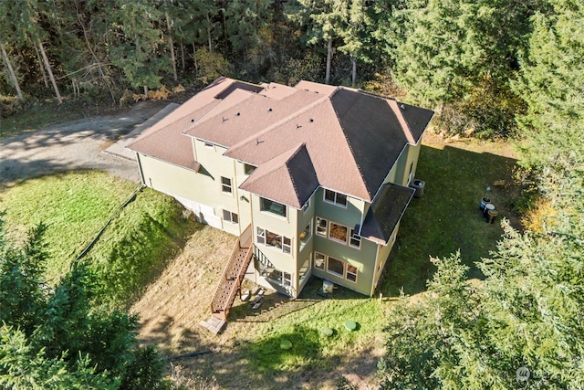 drone / aerial view featuring a view of trees