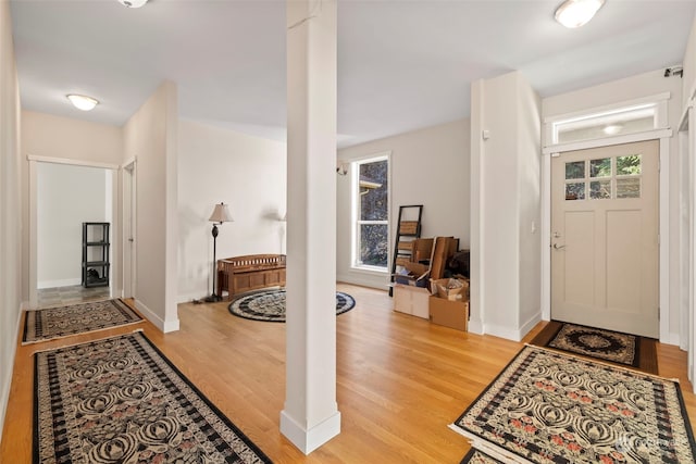 foyer featuring light wood-style flooring and baseboards