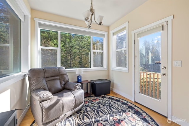 sunroom / solarium with a chandelier and a wealth of natural light