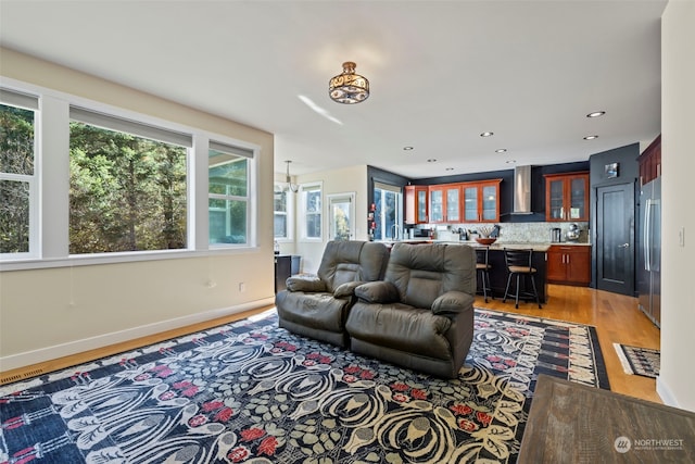 living room featuring light wood-type flooring and an inviting chandelier