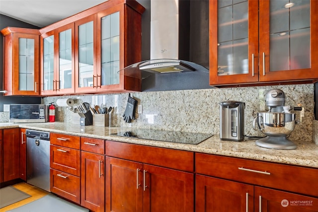 kitchen featuring appliances with stainless steel finishes, light stone counters, backsplash, and wall chimney exhaust hood